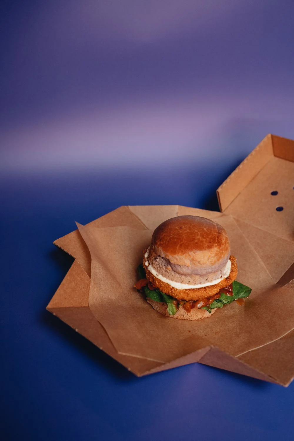 Burger in a plain cardboard takeout box